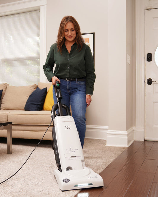 Woman using a vacuum cleaner in a living room.
