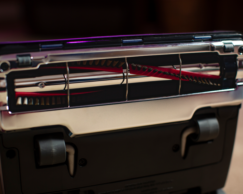 Close-up of a vacuum metal bottom plate with a metal brushroll.